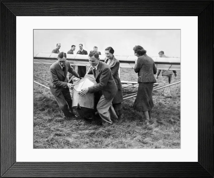 Framed Print : Cramlington Gliding Club members hauling into position their new machine Framed Print : Cramlington Gliding Club members hauling into position their new machine