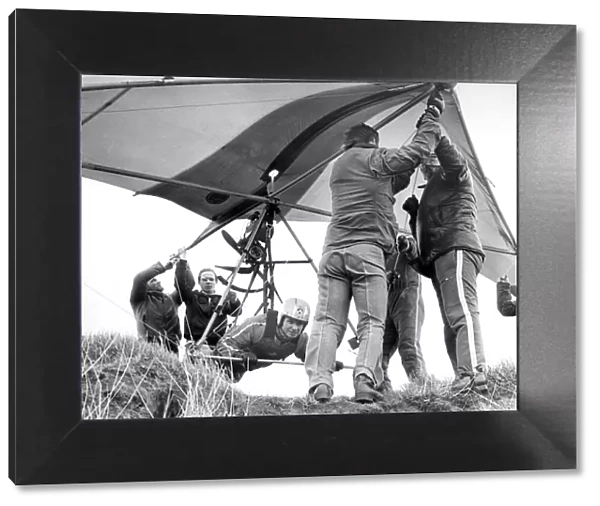 Helping hands get Gordon Smith ready to take to the air in his Hang Glider in April 1978
