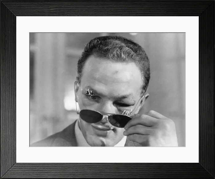 Framed Print : Henry Cooper, the new British and Empire Heavyweight boxing champion looks from behind Framed Print : Henry Cooper, the new British and Empire Heavyweight boxing champion looks from behind