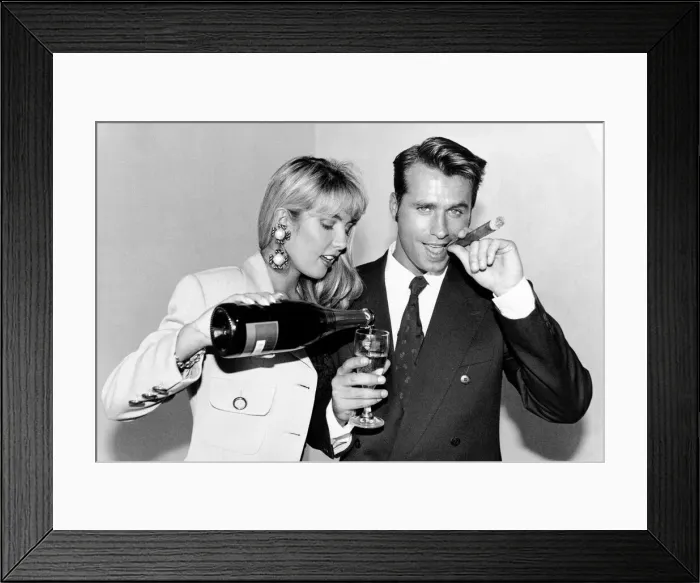 Framed Print : Yuppie couple drinking champagne and smoking cigars Framed Print : Yuppie couple drinking champagne and smoking cigars