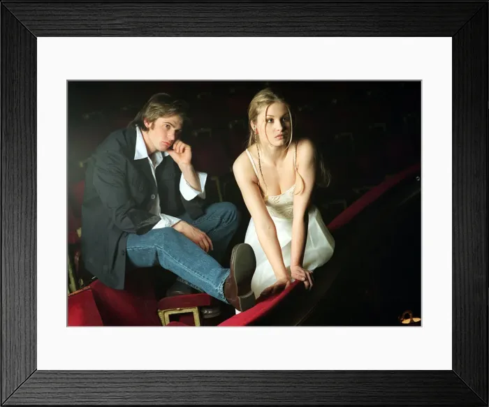Framed Print : Model couple sitting on red cinema seats Framed Print : Model couple sitting on red cinema seats
