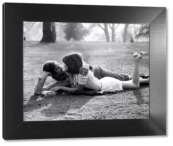 Love and romance A couple lie entwined on a mans coat in the park, May 1971