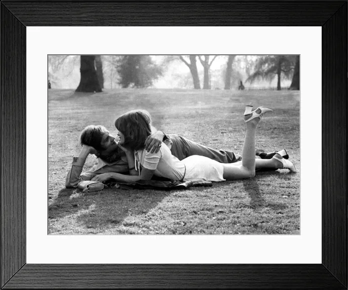 Framed Print : Love and romance A couple lie entwined on a mans coat in the park, May 1971 Framed Print : Love and romance A couple lie entwined on a mans coat in the park, May 1971