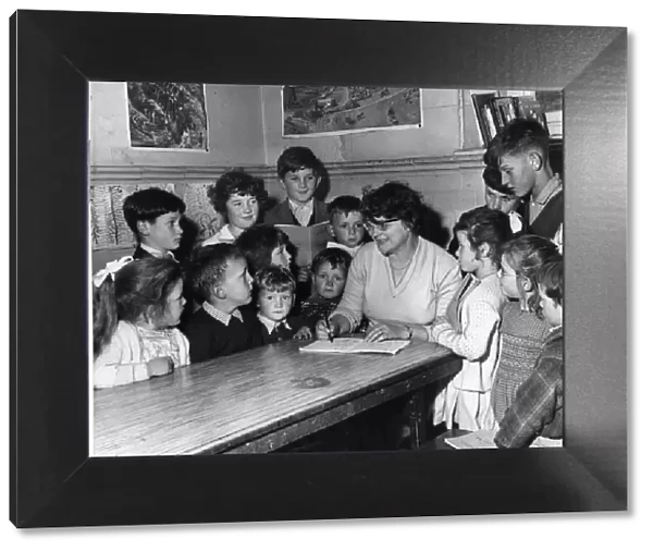 Tryweryn Valley - Mrs Martha Roberts marks the books of her young pupils in the one room