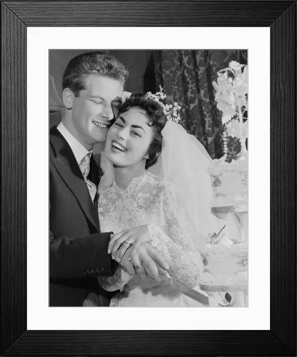 Framed Print : Pamela and David Moore cut the cake at their reception. Pamela was the Daily Mirror