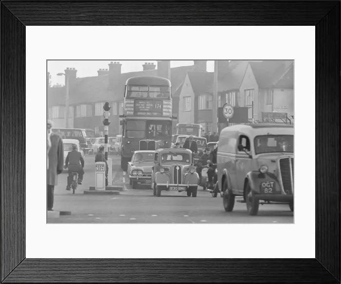 Framed Print : Traffic in High Street Dagenham as the Ford factory turns out at the end of the day shift
