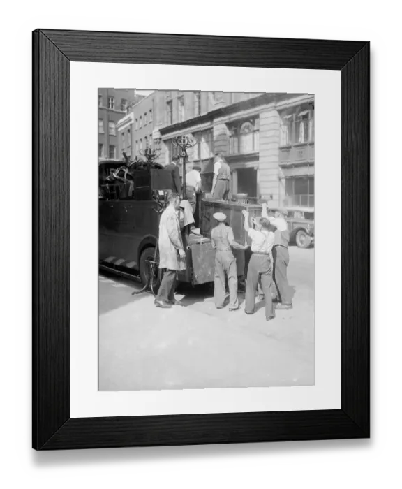 Framed Print : Removal men seen here packing up office furniture from a City of London business which