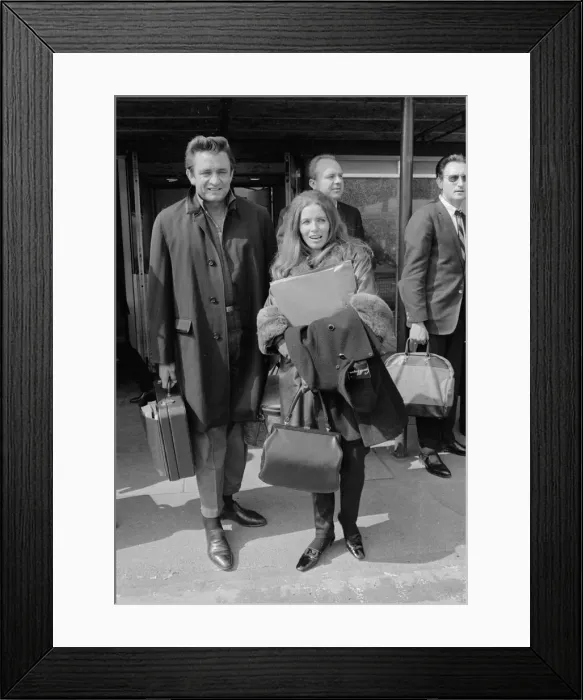 Framed Print : American country singer Johnny Cash with his wife June Carter arriving at Heathrow Framed Print : American country singer Johnny Cash with his wife June Carter arriving at Heathrow