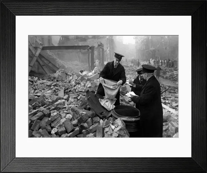 Framed Print : Postmen shift through the wreckage of their central London sorting office looking for Framed Print : Postmen shift through the wreckage of their central London sorting office looking for