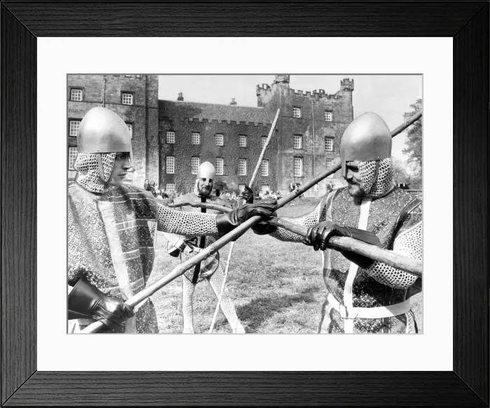 Framed Print : Knaves in jerkins and steel helmets battle with quarter staffs during the jousting Framed Print : Knaves in jerkins and steel helmets battle with quarter staffs during the jousting