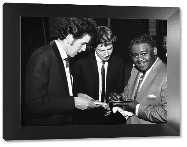 American rock and roll star Fats Domino signs autographs for fans on the stage of