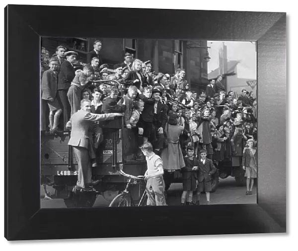 People on the streets celebrate the The VJ day victory parade in Newcastle at the end of