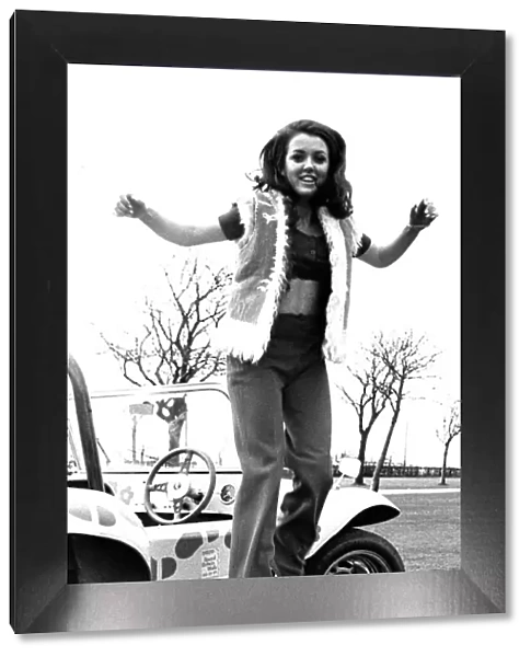 A model in a beach buggy wearing trousers and a fur gillet in April 1970