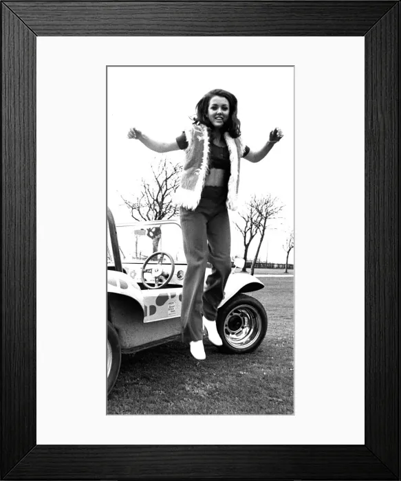 Framed Print : A model in a beach buggy wearing trousers and a fur gillet in April 1970 Framed Print : A model in a beach buggy wearing trousers and a fur gillet in April 1970