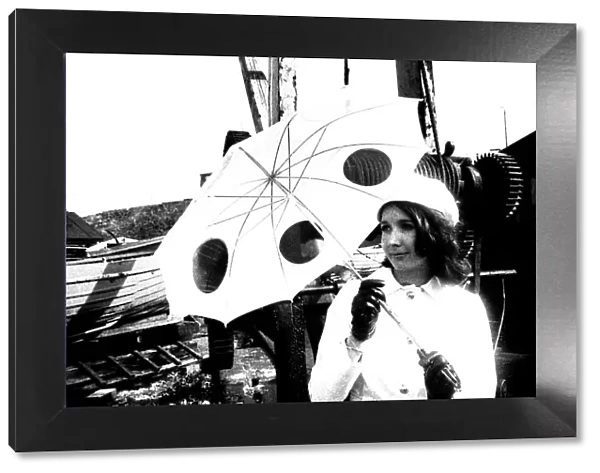 A model posing with and unbrella in April 1970
