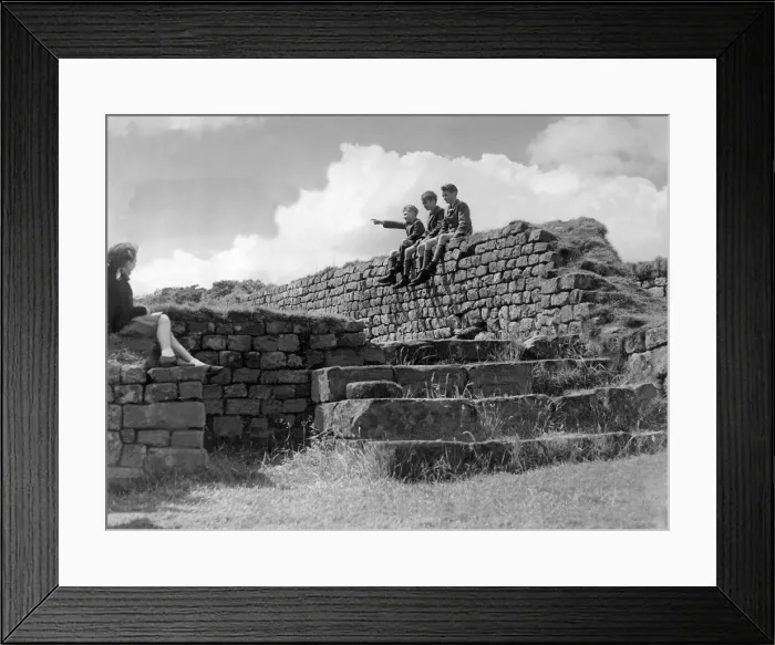 Framed Print : Schoolchildren sitting on the wall of the Roman Granary at Housesteads Fort in Framed Print : Schoolchildren sitting on the wall of the Roman Granary at Housesteads Fort in
