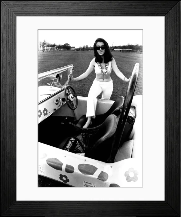 Framed Print : A model in a beach buggy wearing a blouse and trousers in April 1970