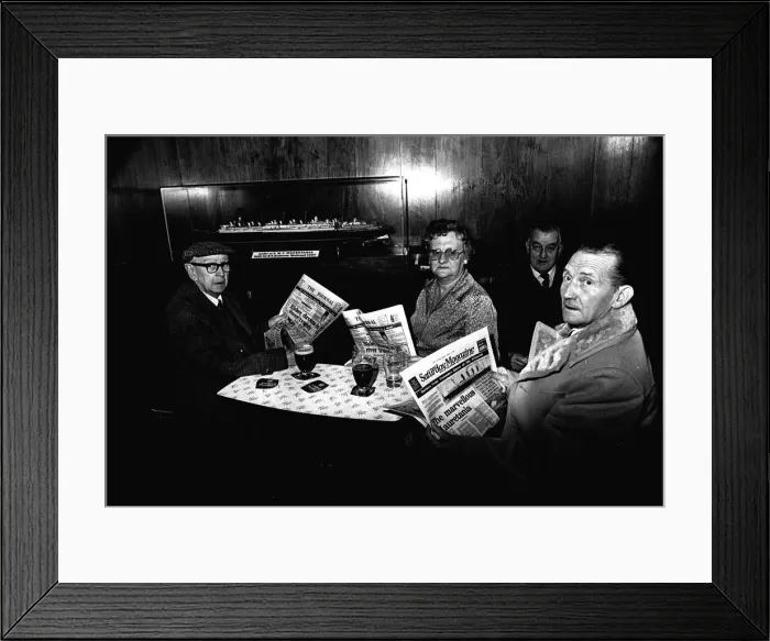 Framed Print : Four regulars at the Mauretania Pub in Wallsend, reading a copy of the Newcastle Journal