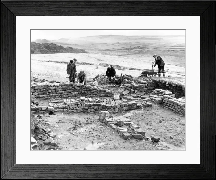 Framed Print : Workmen repair and tidy the remains of the Roman fort at Housesteads in Northumberland in Framed Print : Workmen repair and tidy the remains of the Roman fort at Housesteads in Northumberland in