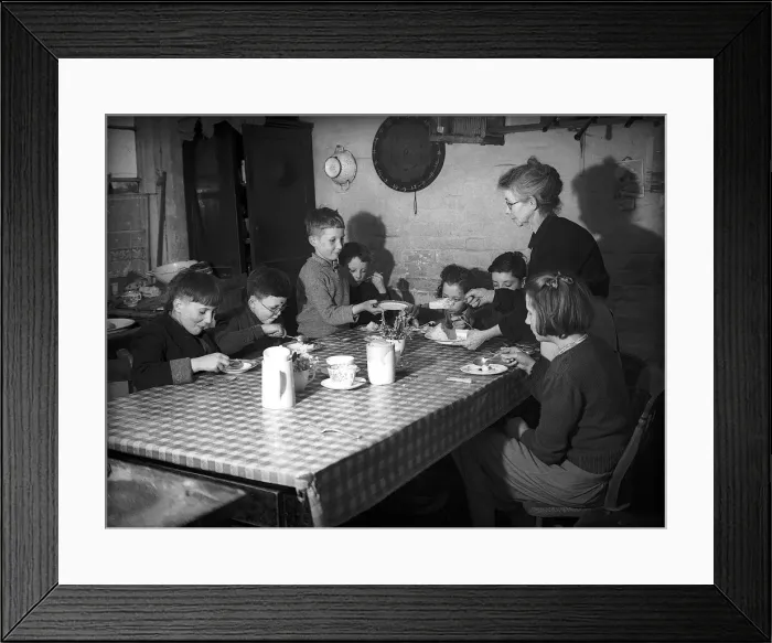Framed Print : Evacuees with women voluntary service helper sitting at table eating food during WW2 Framed Print : Evacuees with women voluntary service helper sitting at table eating food during WW2