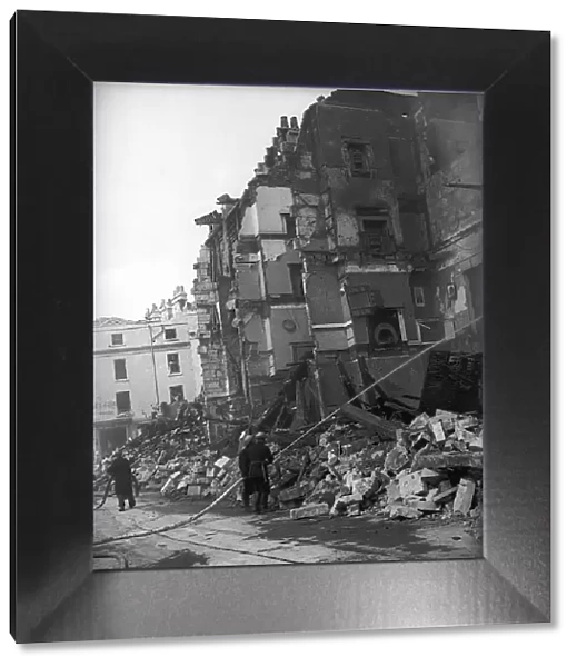 WW2 Bath Bomb Damage. Firemen pump water on the the damaged building 28th April 1942