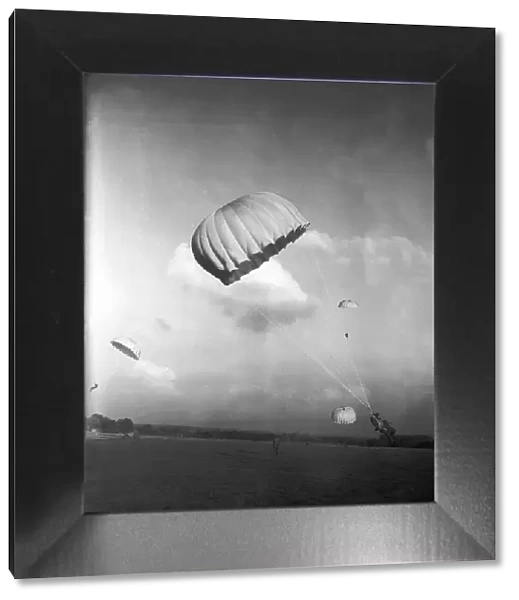 Parachutists in descent and coming to land, during WW2