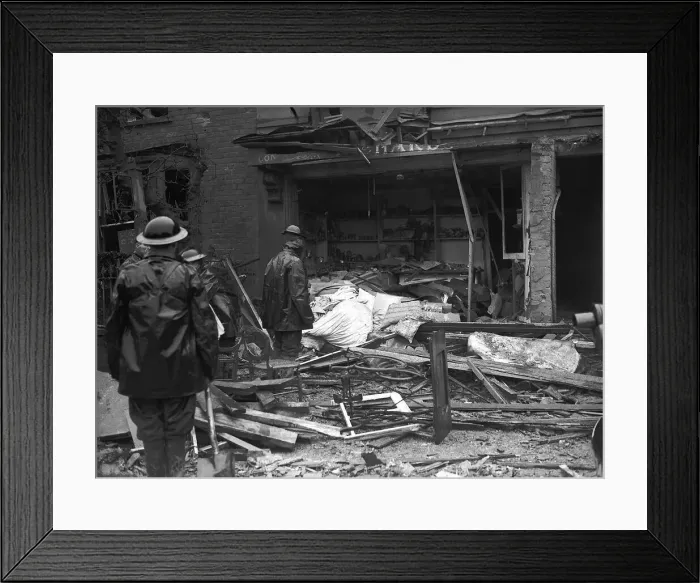 Framed Print : Rescuers looking through bomb damaged building during WW2