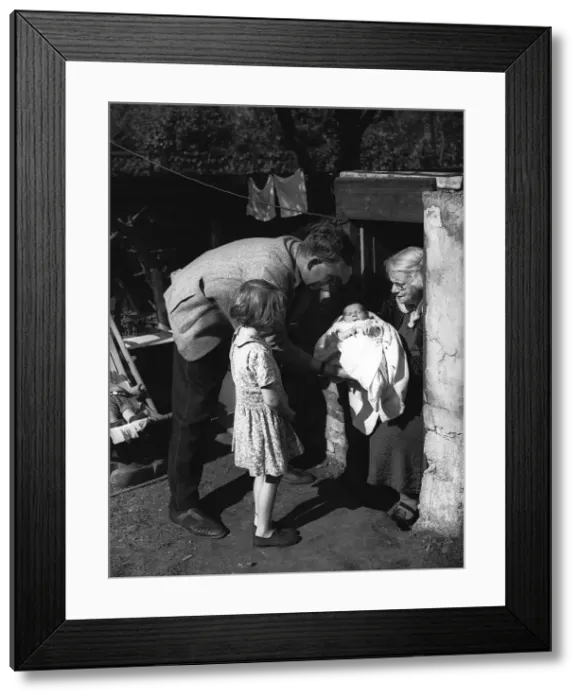 Framed Print : Family coming out of air-raid shelter during WW2 Framed Print : Family coming out of air-raid shelter during WW2