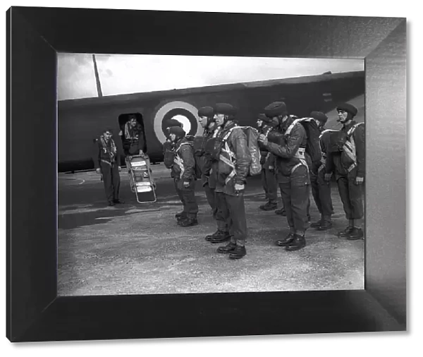 Parachutists during WW2, kitted up for exercise and ready to board plane. Circa 1942