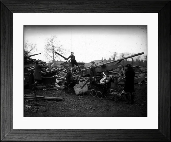Framed Print : Children collecting firewood from bombed building during WW2
