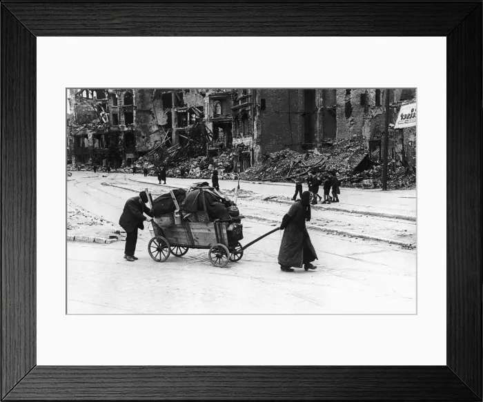 Framed Print : An old woman and her husband July 1945 trundle through the Leipzig Strasse of