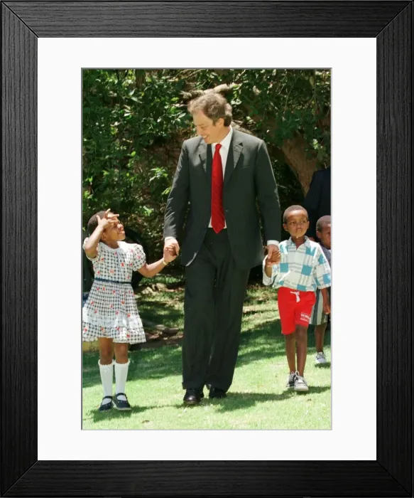 Framed Print : Tony Blair South Africa Visit January 1999 with the Aids child he sponsors Framed Print : Tony Blair South Africa Visit January 1999 with the Aids child he sponsors