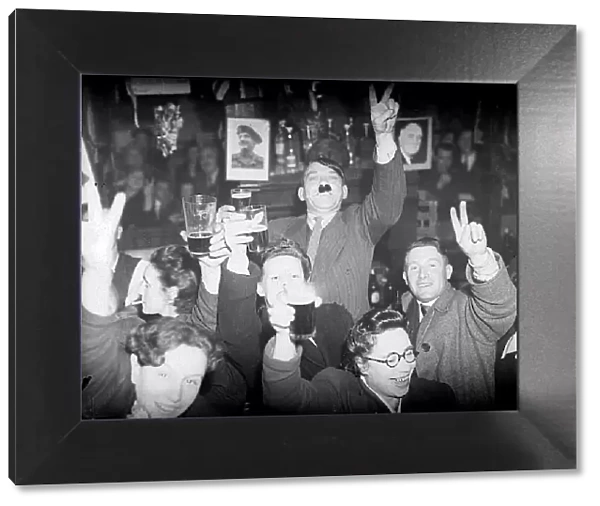 VE day celebrations in Lambeth London as man dresses up as Hitler in a pub saluting with