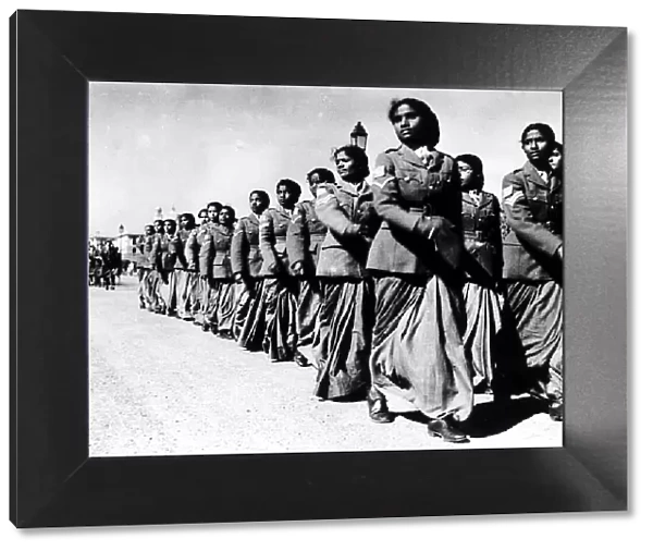 Womens auxiliary corps march past one of the army platoons