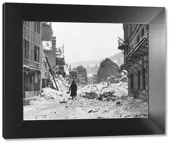A soldiers walks through snow covered ruins of Laroche after it had been shelled by