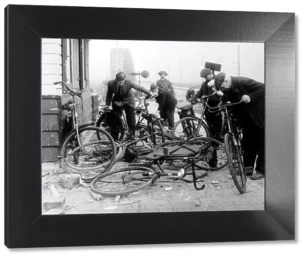 Dutch civilians select bikes left by German soldiers at the end of the Waal Bridge