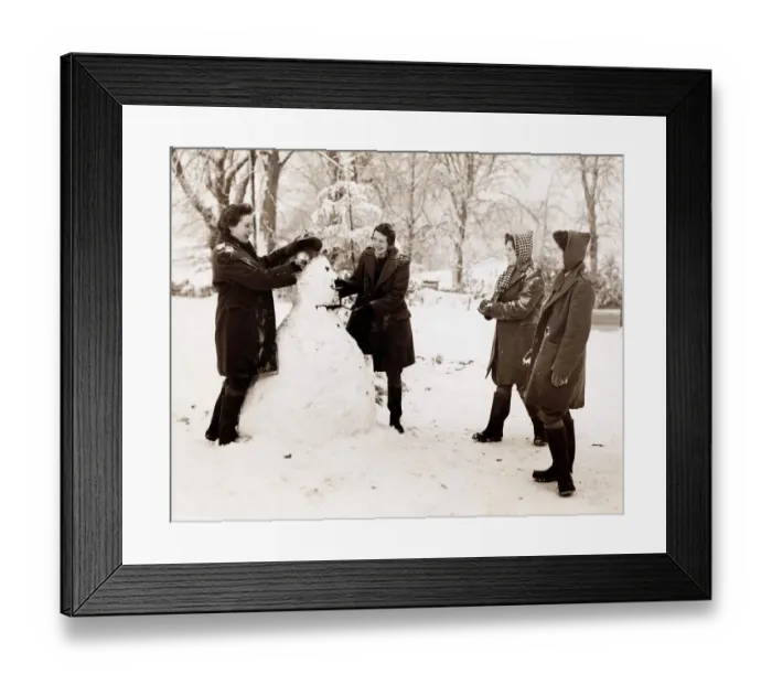 Framed Print : Landgirls on a Sussex farm build a Hitler snowman and then get ready to paste him with Framed Print : Landgirls on a Sussex farm build a Hitler snowman and then get ready to paste him with