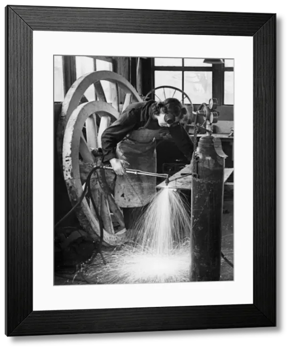 Framed Print : World War Two, Grace Shults at a welding smiths work assembling farm wagons at Great Framed Print : World War Two, Grace Shults at a welding smiths work assembling farm wagons at Great