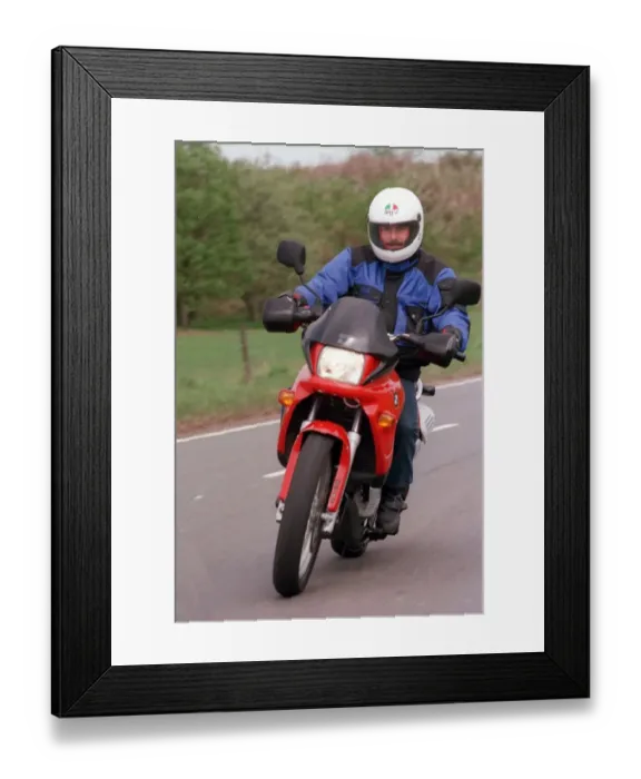 Framed Print : Young Trevor Martin posing on the BMW motor helmetbike circa 1990s BMW F650