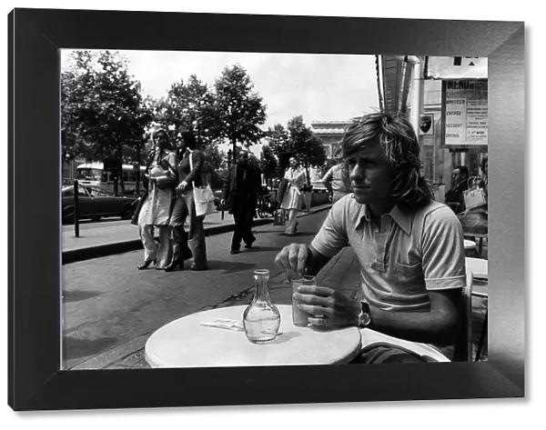 Bjorn Borg tennis player sitting in a cafe on the Champs Elysee in Paris having a drink