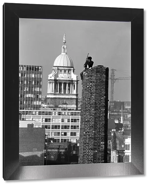 Man demolishes a chimney tower by mallet in London October 1970