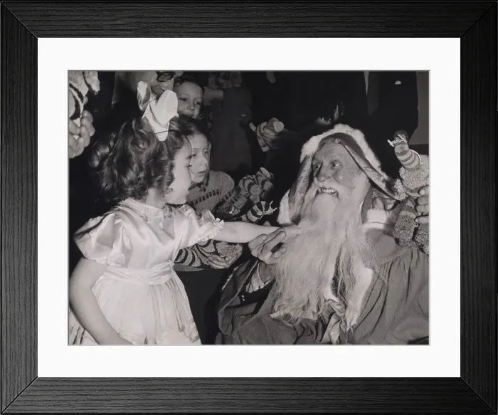 Framed Print : Children pulling Father Christmass beard at a party given by the Merchant Navy Club