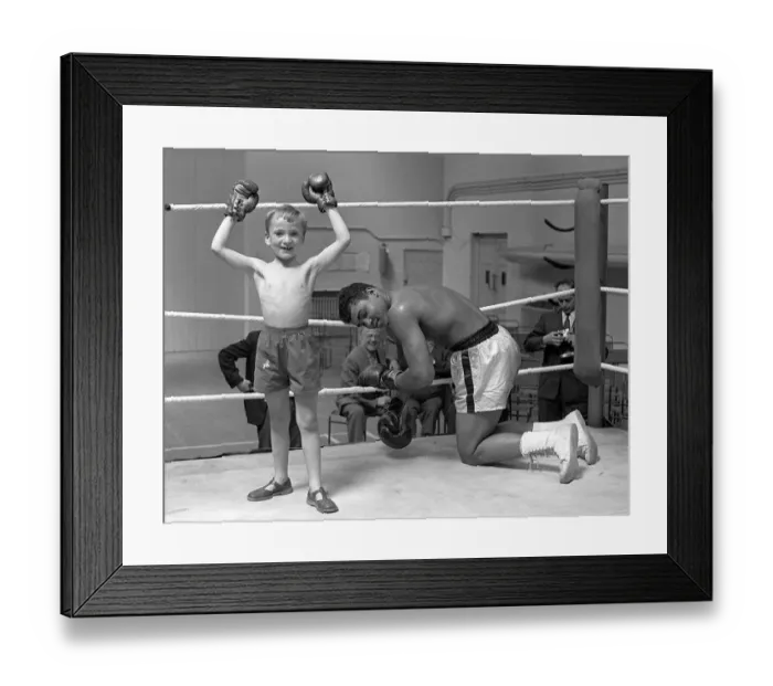 Framed Print : Cassius Clay with 6 year old Patrick Power in the ring during his training for Framed Print : Cassius Clay with 6 year old Patrick Power in the ring during his training for