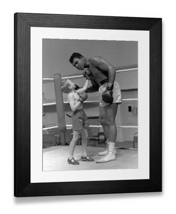 Framed Print : Cassius Clay with 6 year old Patrick Power in the ring during his training for
