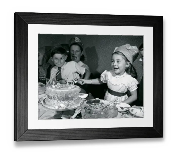 Framed Print : Kids pull crackers at Christmas party 1950 Infront of xmas cake