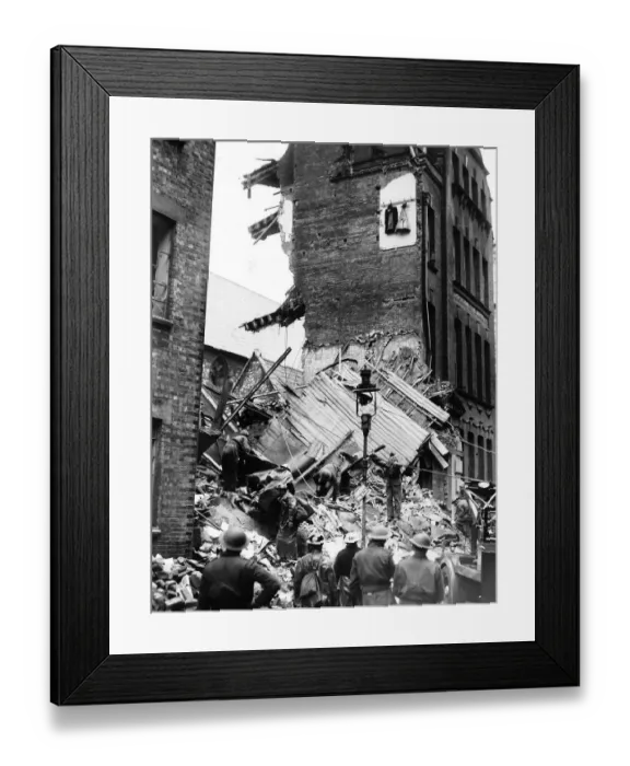 Framed Print : Rescue workers search the rubble after a London office block was hit during a WW2 German Framed Print : Rescue workers search the rubble after a London office block was hit during a WW2 German