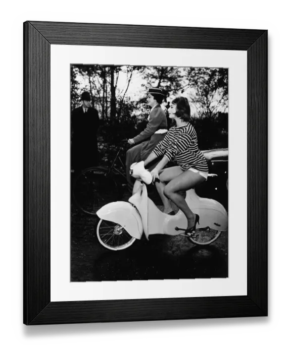 Framed Print : Miss Cycling 1959 riding a Scoo-ped and Miss Cycling 1898 riding an old-fashioned sit up