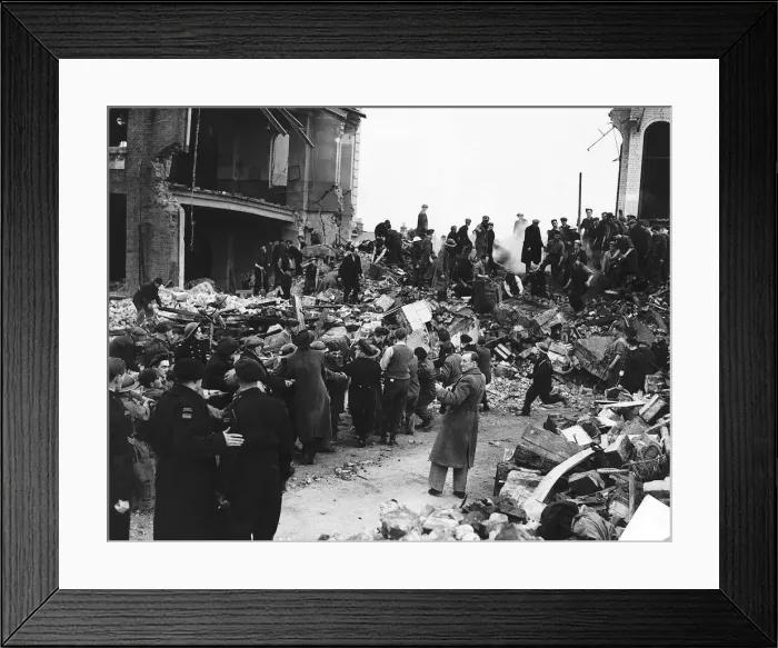 Framed Print : Rescuers search for survivors among the remains of school hit by a bomb during a WW2 air