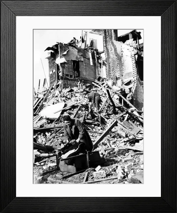 Framed Print : Housewife Mrs Berbiest gathers her belongings from the remains of her home Framed Print : Housewife Mrs Berbiest gathers her belongings from the remains of her home