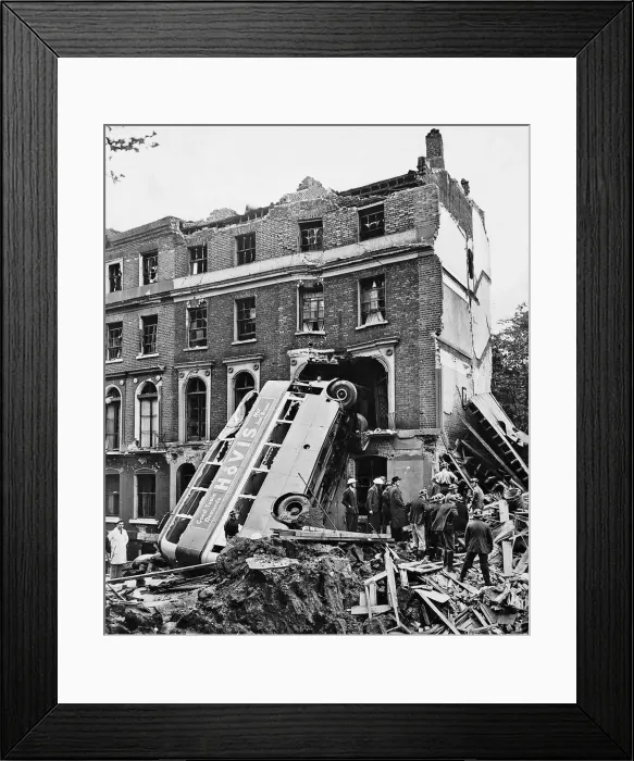Framed Print : A London double decker bus hit by the blast from a bomb dropped during an air raid Framed Print : A London double decker bus hit by the blast from a bomb dropped during an air raid